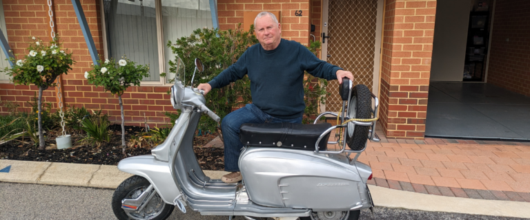 brian standing with moped for men's health week